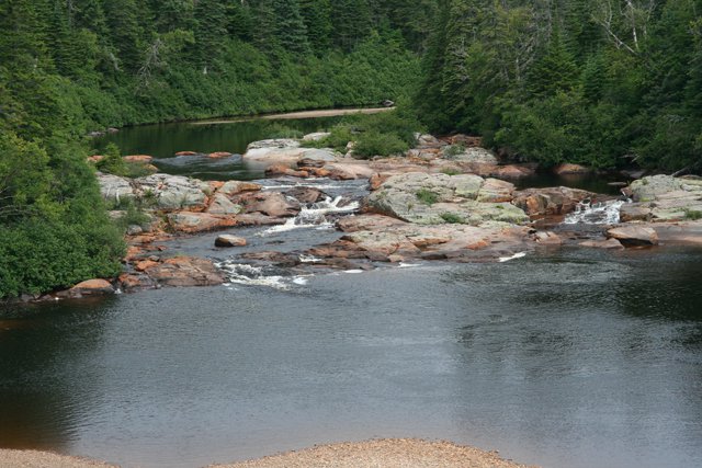 QB North Shore Hwy-Rusty rock in river  James Stoness.JPG