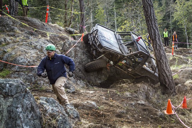 Spotter Rob Reid gets out of the way of Sam Erck as he pushes his 4Runner through the course at the Island Cup.jpeg