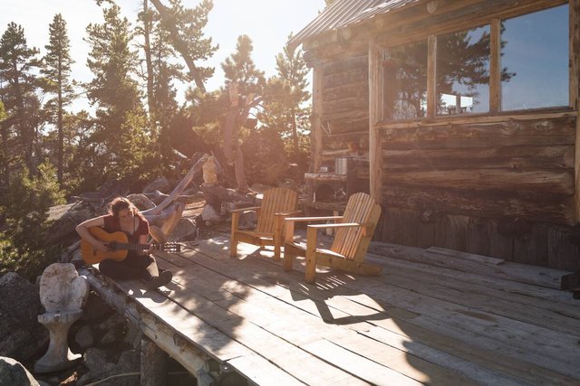 Guitarist and cabin at Nuk Tessli Wilderness Experience