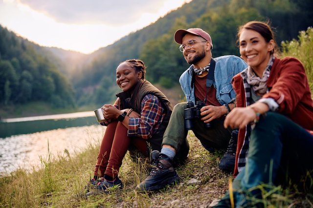 Multiracial group of friends enjoying while spending their weekend in nature.